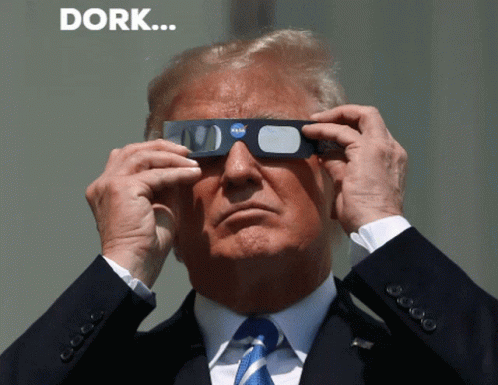 A Man In A Suit And Tie Is Wearing A Pair Of Nasa Glasses GIF