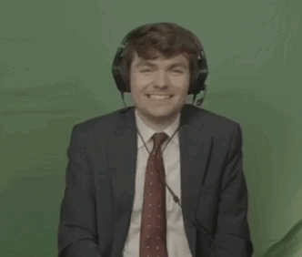 A Man In A Suit And Tie Is Wearing Headphones And A Headset . GIF