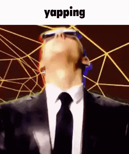 A Man In A Suit And Tie Is Wearing Sunglasses And Looking Up With The Word Yapping Below Him GIF