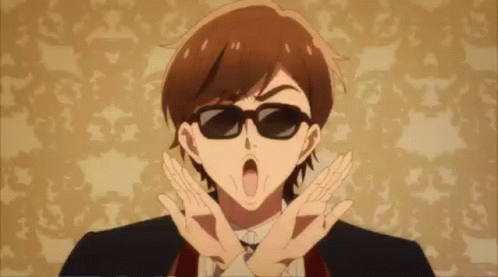 A Man In A Suit And Tie Is Wearing Sunglasses And Making A Peace Sign . GIF