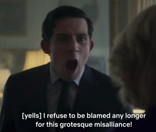 A Man In A Suit And Tie Is Yelling At A Woman GIF