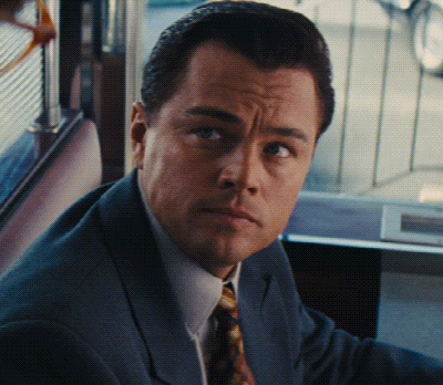 A Man In A Suit And Tie Looks At The Camera With A Serious Look On His Face GIF