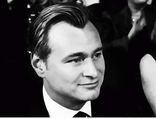 A Man In A Suit And Tie Looks At The Camera GIF