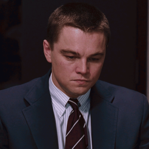 A Man In A Suit And Tie Looks Serious GIF