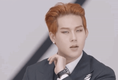 A Man In A Suit And Tie Makes A Heart Shape With His Hands GIF