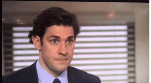 A Man In A Suit And Tie Making A Face GIF