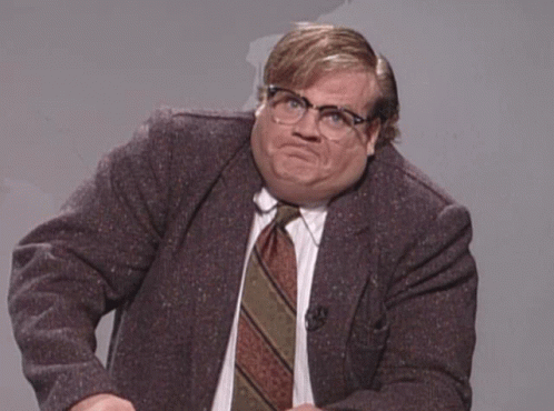 A Man In A Suit And Tie Making A Face GIF
