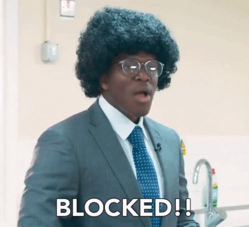 A Man In A Suit And Tie Says Blocked In White Letters GIF