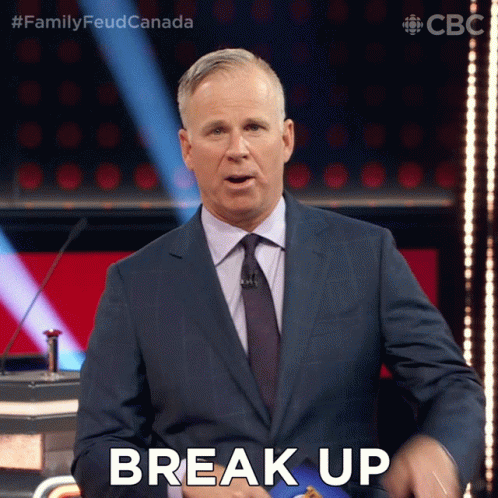 A Man In A Suit And Tie Says Break Up On A Stage GIF