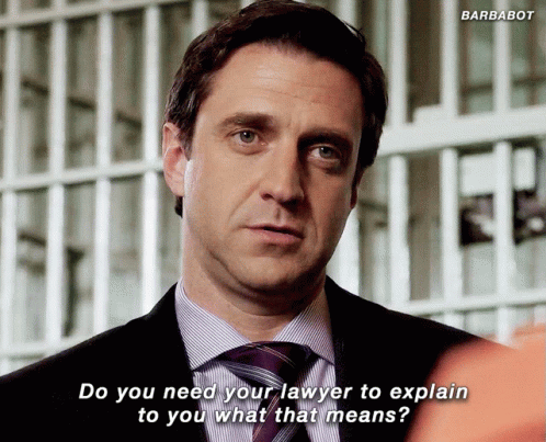 a man in a suit and tie says do you need your lawyer to explain to you what that means ..