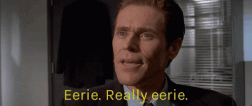 A Man In A Suit And Tie Says Eerie GIF