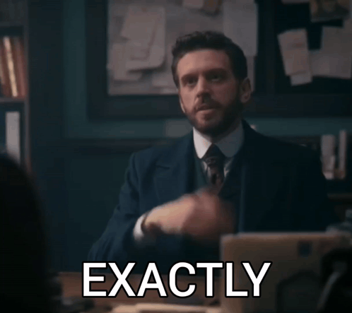 A Man In A Suit And Tie Says Exactly In Front Of A Laptop Computer GIF