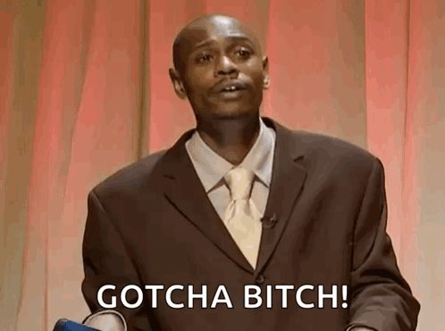 A Man In A Suit And Tie Says Gotcha Bitch . GIF