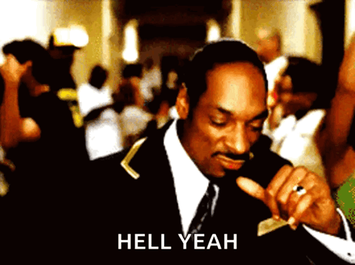 A Man In A Suit And Tie Says Hell Yeah In Front Of A Crowd GIF