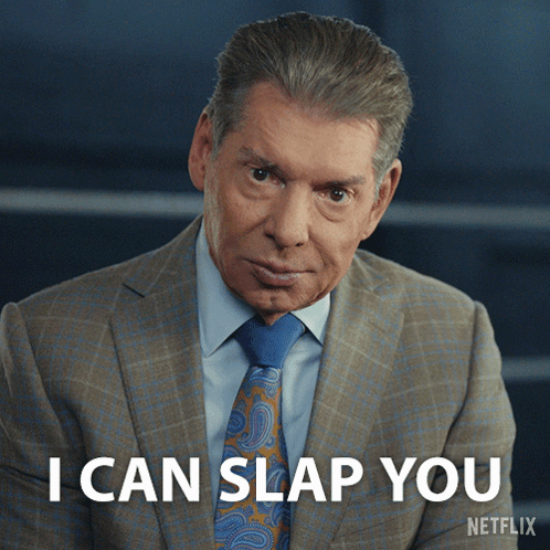 A Man In A Suit And Tie Says I Can Slap You On A Netflix Screen GIF