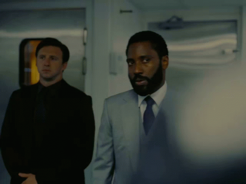 A Man In A Suit And Tie Says " I Ordered My Hot Sauce An Hour Ago " In A Dark Room GIF