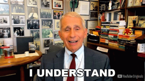 A Man In A Suit And Tie Says " I Understand " In Front Of A Wall Of Pictures GIF