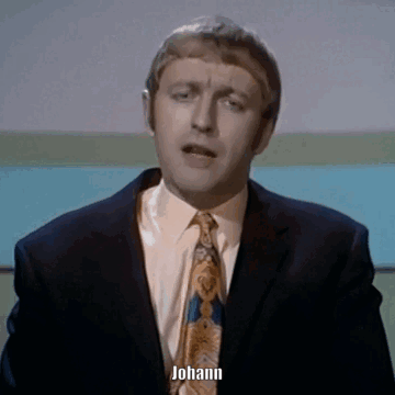 A Man In A Suit And Tie Says Johann In Front Of A Blue Background GIF