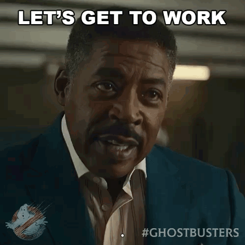 A Man In A Suit And Tie Says " Let 'S Get To Work " GIF