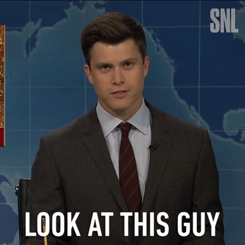 A Man In A Suit And Tie Says Look At This Guy In Front Of A Map GIF