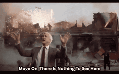 A Man In A Suit And Tie Says " Move On There Is Nothing To See Here " In Front Of A Destroyed City GIF