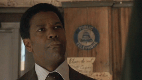 A Man In A Suit And Tie Says " My Man " In Front Of A Public Telephone Sign GIF