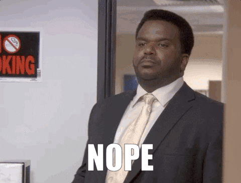 A Man In A Suit And Tie Says Nope In Front Of A No Smoking Sign . GIF