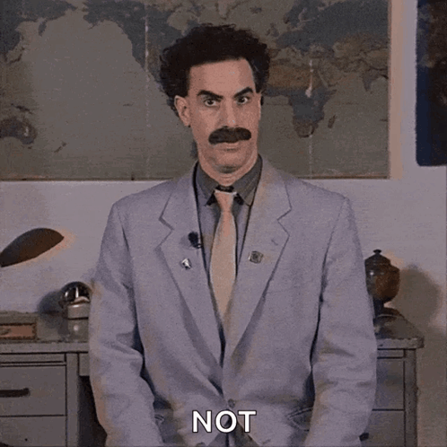 A Man In A Suit And Tie Says Not In Front Of A Map Of The World GIF