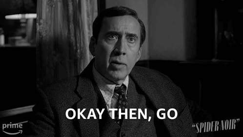 A Man In A Suit And Tie Says Okay Then Go In A Black And White Photo GIF