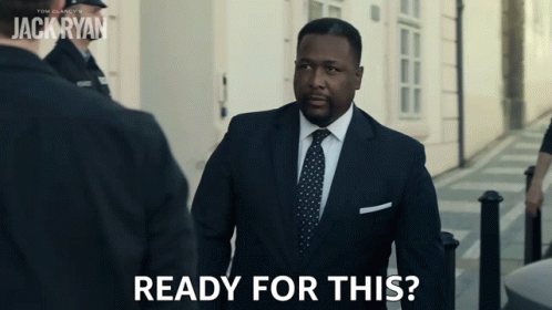 A Man In A Suit And Tie Says " Ready For This " As He Walks Down A Street GIF