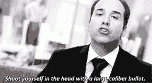 A Man In A Suit And Tie Says Shoot Yourself In The Head With A Larger Caliber Bullet GIF