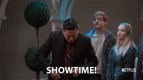 A Man In A Suit And Tie Says Showtime In Front Of A Netflix Logo GIF