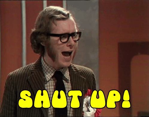 A Man In A Suit And Tie Says Shut Up In Yellow Letters GIF