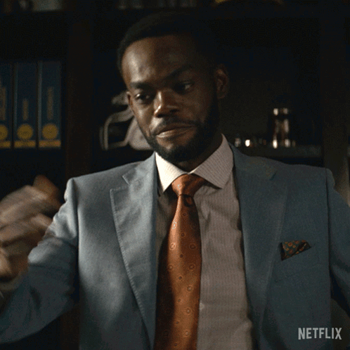A Man In A Suit And Tie Says Sit Down In A Netflix Advertisement GIF