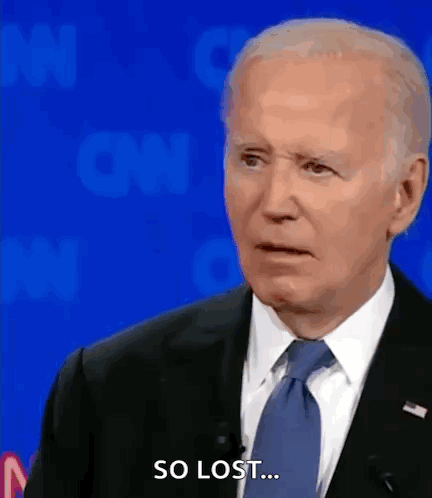 A Man In A Suit And Tie Says So Lost While Standing In Front Of A Blue Background . GIF