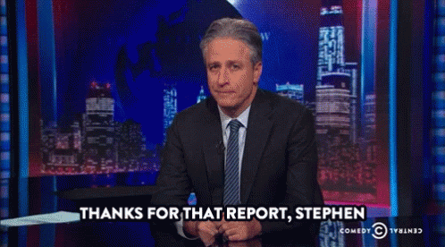A Man In A Suit And Tie Says Thanks For That Report Stephen On A Comedy Central Show GIF