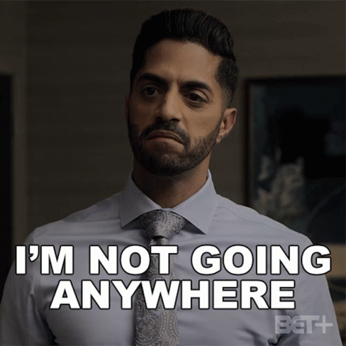 A Man In A Suit And Tie Says That He Is Not Going Anywhere GIF