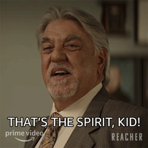 A Man In A Suit And Tie Says That 'S The Spirit Kid Reacher GIF
