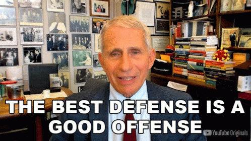 A Man In A Suit And Tie Says The Best Defense Is A Good Offense In Front Of A Wall Of Pictures GIF