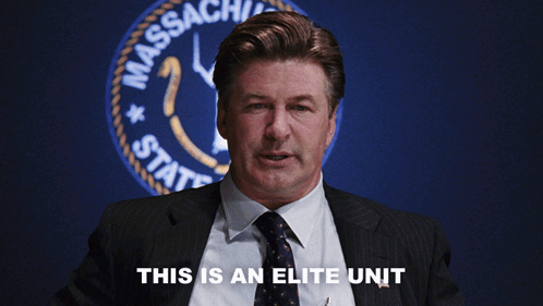 A Man In A Suit And Tie Says This Is An Elite Unit In Front Of A Massachusetts State Seal GIF