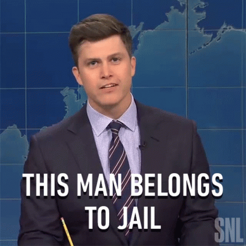 A Man In A Suit And Tie Says This Man Belongs To Jail While Holding A Pencil GIF