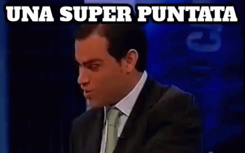 A Man In A Suit And Tie Says Una Super Puntata On A Blue Background GIF