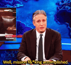 A Man In A Suit And Tie Says Well Mission F & King Accomplished In Front Of A Map Of The World GIF