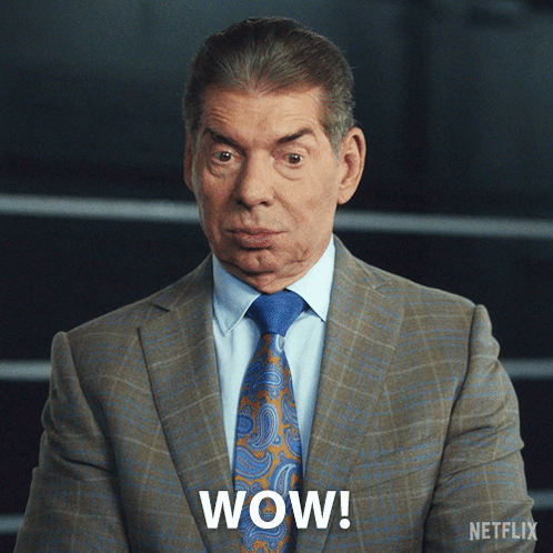 A Man In A Suit And Tie Says Wow On The Screen GIF