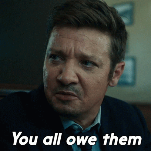 A Man In A Suit And Tie Says " You All Owe Them " In White Letters GIF