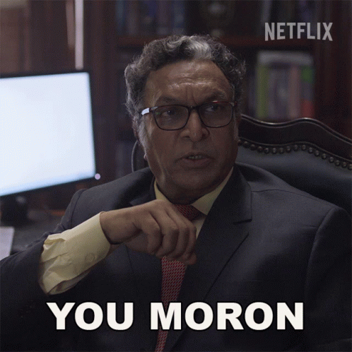 A Man In A Suit And Tie Says You Moron In Front Of A Netflix Logo GIF