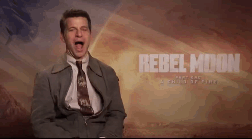 A Man In A Suit And Tie Screams In Front Of A Rebel Moon Part One Poster GIF