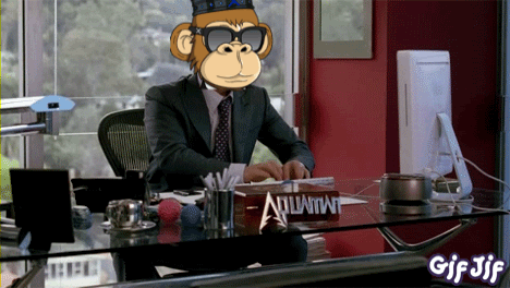 A Man In A Suit And Tie Sits At A Desk With A Sign That Says Atlantis GIF