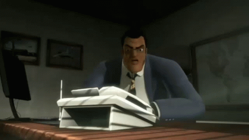 A Man In A Suit And Tie Sits At A Desk With A Stack Of Papers On It GIF