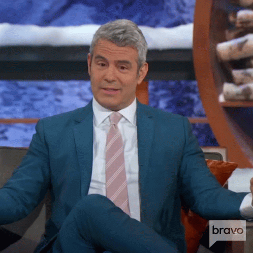 Man In Suit Sitting On Couch With Bravo Logo GIF